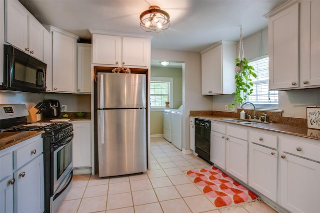 1211 Lansford Ave, Dallas, TX 75224 - kitchen featuring black appliances, separate washer and dryer, and white cabinetry