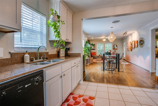 1211 Lansford Ave, Dallas, TX 75224 - kitchen with black dishwasher, white cabinets, light wood-style flooring, and stone counters