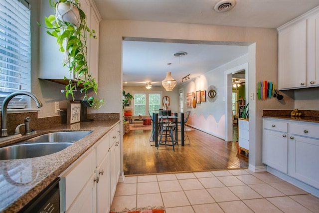 1211 Lansford Ave, Dallas, TX 75224 - kitchen with ceiling fan, white cabinets, dark stone countertops, and decorative light fixtures