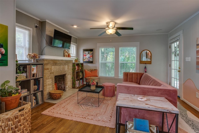 1211 Lansford Ave, Dallas, TX 75224 - living area with wood finished floors, a fireplace with flush hearth, healthy amount of natural light, and ornamental molding