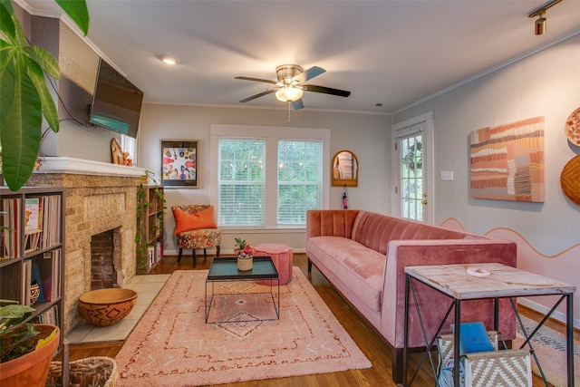 1211 Lansford Ave, Dallas, TX 75224 - living room featuring wood finished floors, ceiling fan, a fireplace, and ornamental molding