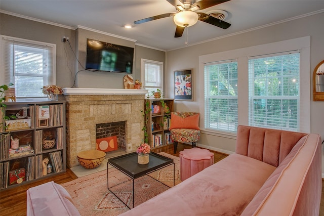 1211 Lansford Ave, Dallas, TX 75224 - living room featuring wood finished floors, plenty of natural light, ceiling fan, crown molding, and a fireplace