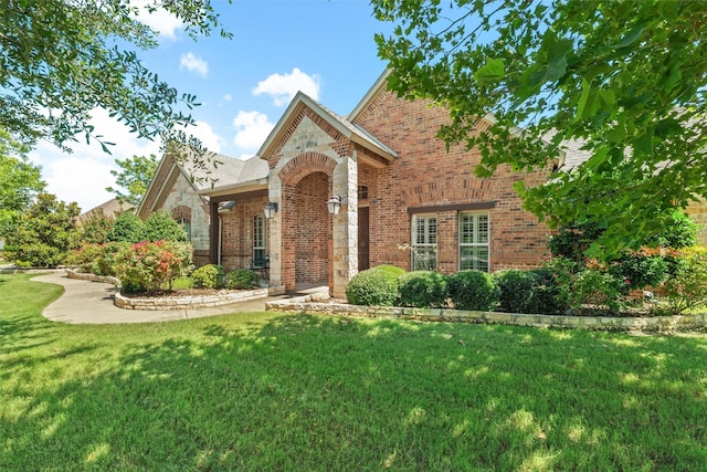 5820 Shiloh Forest Dr, Midlothian, TX 76065 - view of front of house featuring brick siding, a front yard, and stone siding
