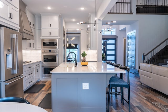 9901 Mi Tierra Dr, Fort Worth, TX 76179 - kitchen with stainless steel appliances, custom exhaust hood, dark wood-type flooring, light countertops, and recessed lighting