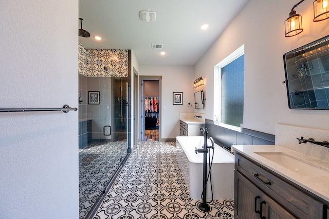 9901 Mi Tierra Dr, Fort Worth, TX 76179 - full bath with a stall shower, two vanities, a freestanding tub, and recessed lighting