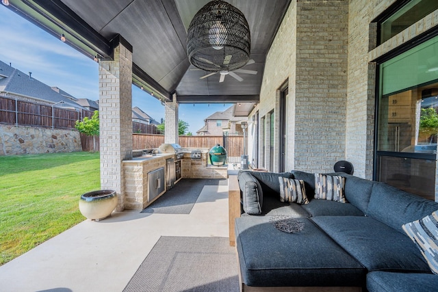 9901 Mi Tierra Dr, Fort Worth, TX 76179 - fenced backyard with an outdoor kitchen, an outdoor hangout area, a ceiling fan, and a patio area