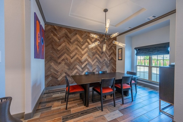 9901 Mi Tierra Dr, Fort Worth, TX 76179 - dining room featuring a raised ceiling, wood finished floors, an accent wall, and a chandelier
