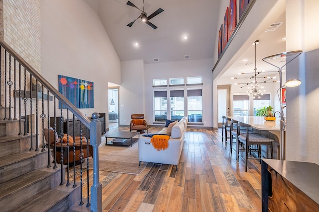 9901 Mi Tierra Dr, Fort Worth, TX 76179 - living area with high vaulted ceiling, hardwood / wood-style flooring, stairway, ceiling fan, and a chandelier