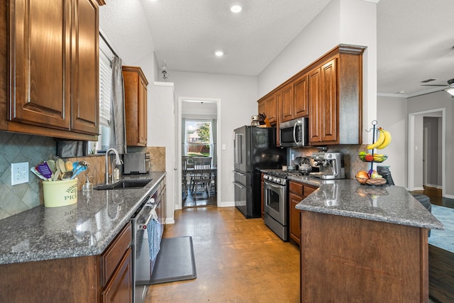 1617 Shadywood Ln, Flower Mound, TX 75028 - kitchen with stainless steel appliances, decorative backsplash, dark stone countertops, recessed lighting, and a peninsula