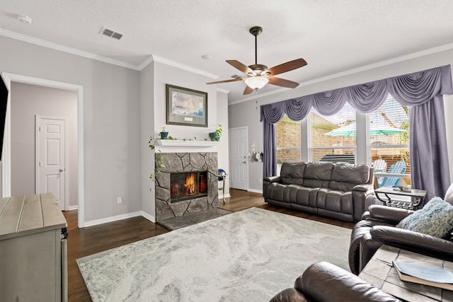 1617 Shadywood Ln, Flower Mound, TX 75028 - living area with dark wood-type flooring, crown molding, a fireplace, a ceiling fan, and a textured ceiling