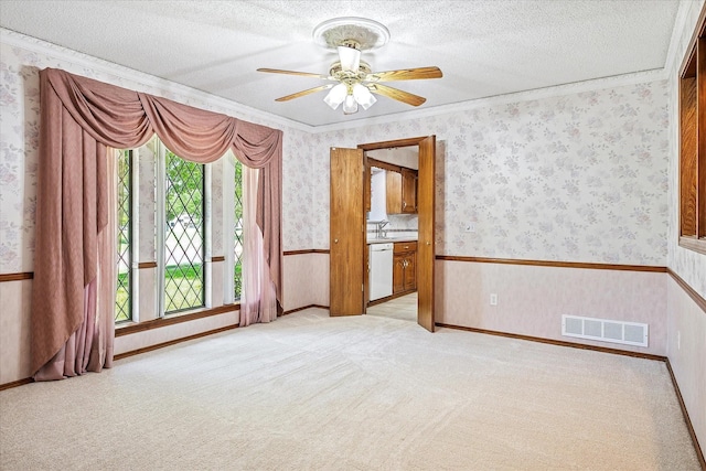 4120 Merriman Dr, Plano, TX 75074 - empty room with wallpapered walls, a ceiling fan, light colored carpet, ornamental molding, and a textured ceiling