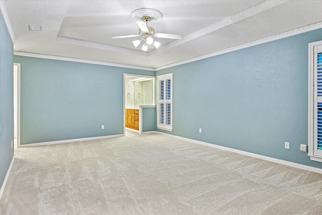 4120 Merriman Dr, Plano, TX 75074 - empty room with a raised ceiling, carpet floors, a ceiling fan, a textured ceiling, and ornamental molding