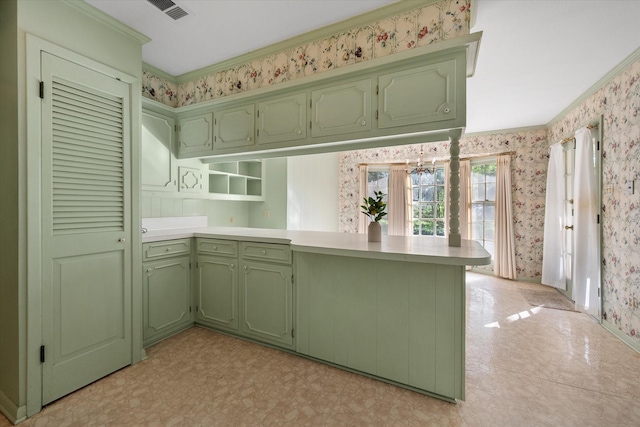1008 Dobbins Rd, Corsicana, TX 75110 - kitchen with green cabinets, wallpapered walls, a peninsula, light countertops, and ornamental molding