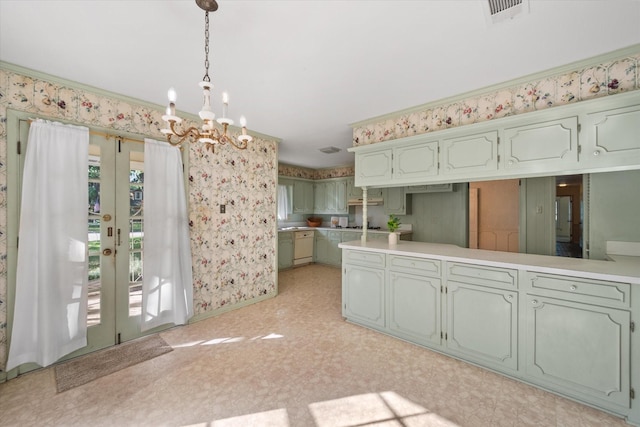 1008 Dobbins Rd, Corsicana, TX 75110 - kitchen featuring a chandelier, pendant lighting, green cabinets, light countertops, and wallpapered walls