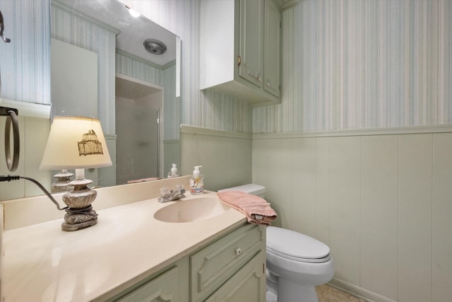 1008 Dobbins Rd, Corsicana, TX 75110 - bathroom with wallpapered walls, vanity, wainscoting, and a shower with shower door