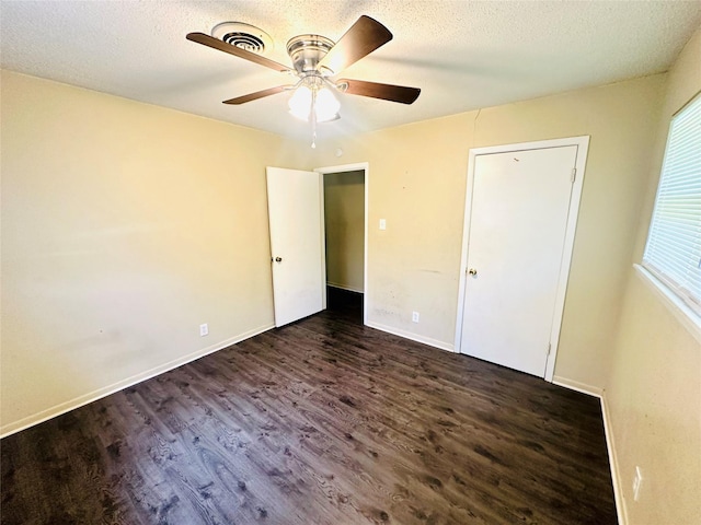 1220 Crestview Dr, Kaufman, TX 75142 - unfurnished bedroom featuring dark wood finished floors, ceiling fan, and a textured ceiling