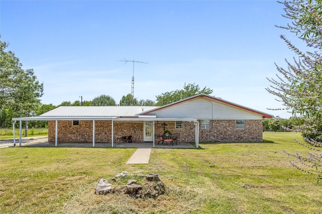 1748 Old Southmayd Rd, Sherman, TX 75092 - back of property featuring a yard, brick siding, a carport, and a patio