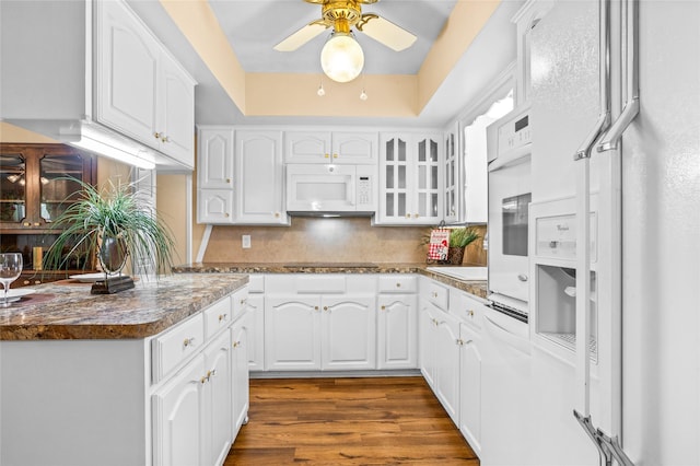 1748 Old Southmayd Rd, Sherman, TX 75092 - kitchen with white appliances, decorative backsplash, glass insert cabinets, ceiling fan, and white cabinetry