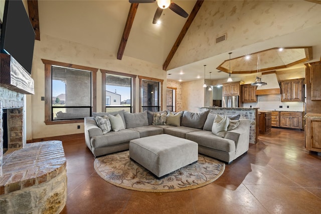 13431 Kira Ln, Justin, TX 76247 - living room with high vaulted ceiling, finished concrete flooring, beamed ceiling, ceiling fan, and a fireplace