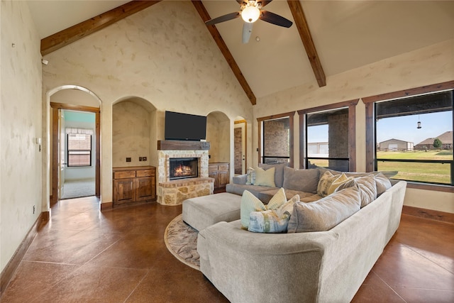 13431 Kira Ln, Justin, TX 76247 - living area with plenty of natural light, arched walkways, a stone fireplace, high vaulted ceiling, and beam ceiling