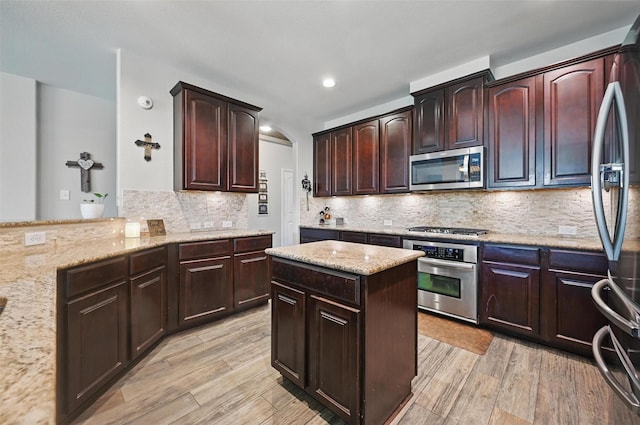 1000 Barn Owl Dr, Little Elm, TX 75068 - kitchen featuring stainless steel appliances, light wood finished floors, light stone counters, backsplash, and recessed lighting