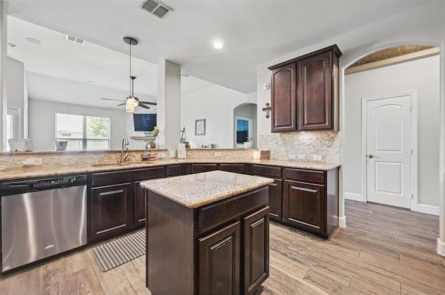 1000 Barn Owl Dr, Little Elm, TX 75068 - kitchen with dishwasher, arched walkways, a ceiling fan, light wood-style floors, and dark brown cabinets