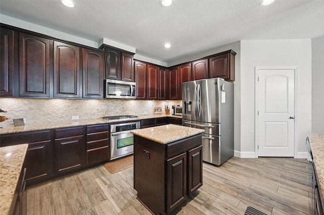 1000 Barn Owl Dr, Little Elm, TX 75068 - kitchen featuring stainless steel appliances, light wood-style floors, backsplash, dark brown cabinets, and recessed lighting