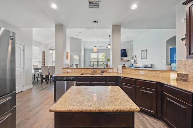 1000 Barn Owl Dr, Little Elm, TX 75068 - kitchen featuring appliances with stainless steel finishes, a ceiling fan, light stone counters, open floor plan, and recessed lighting