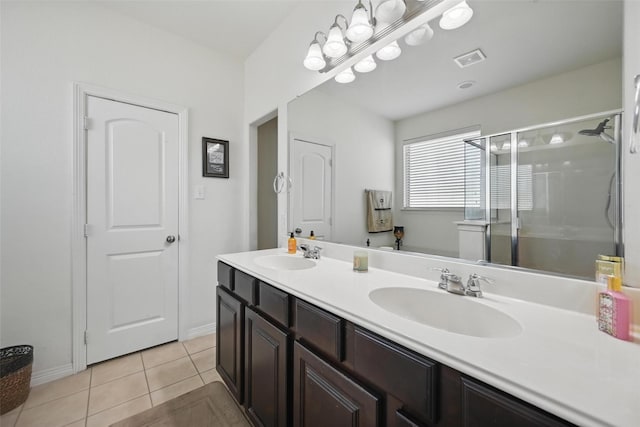 1000 Barn Owl Dr, Little Elm, TX 75068 - bathroom with a stall shower, double vanity, and tile patterned flooring