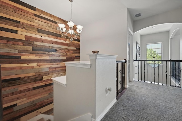 1000 Barn Owl Dr, Little Elm, TX 75068 - corridor featuring wooden walls, a chandelier, an upstairs landing, carpet floors, and arched walkways