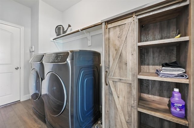 1000 Barn Owl Dr, Little Elm, TX 75068 - laundry room featuring separate washer and dryer, wood finished floors, and a barn door