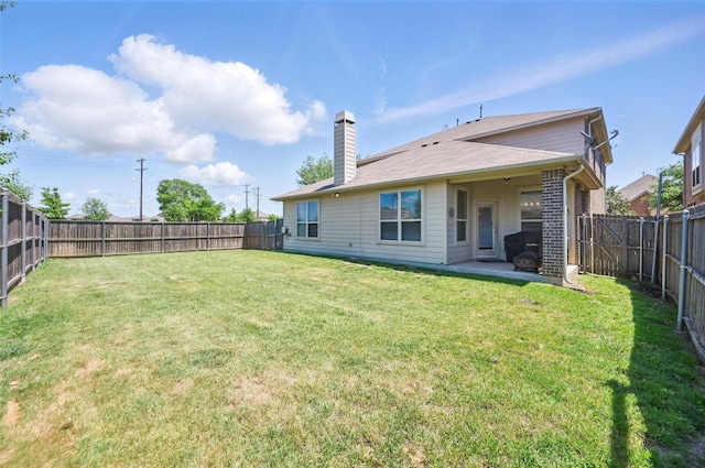 1000 Barn Owl Dr, Little Elm, TX 75068 - back of property featuring a fenced backyard, a chimney, and a patio area
