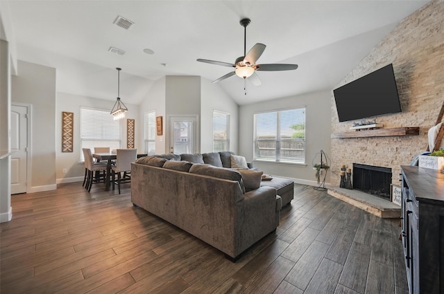 1000 Barn Owl Dr, Little Elm, TX 75068 - living room with lofted ceiling, a ceiling fan, a stone fireplace, and dark wood-style flooring