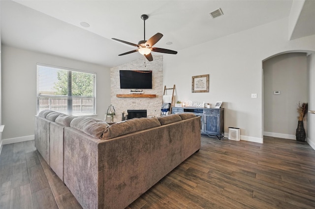 1000 Barn Owl Dr, Little Elm, TX 75068 - living room featuring arched walkways, ceiling fan, a fireplace, dark wood-style floors, and vaulted ceiling