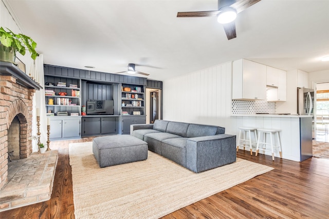 2528 Royal Ln, Denton, TX 76209 - living room featuring a ceiling fan, wood finished floors, and a fireplace