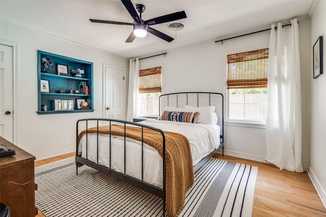 2528 Royal Ln, Denton, TX 76209 - bedroom with light wood finished floors, multiple windows, ceiling fan, and crown molding