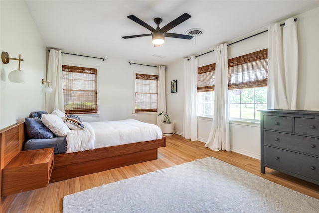 2528 Royal Ln, Denton, TX 76209 - bedroom featuring wood finished floors, multiple windows, and a ceiling fan