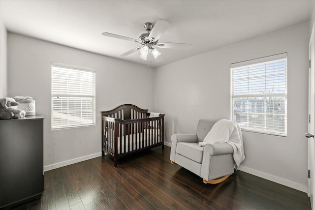 2648 Mark Dr, Mesquite, TX 75150 - bedroom featuring multiple windows, wood finished floors, a nursery area, and a ceiling fan