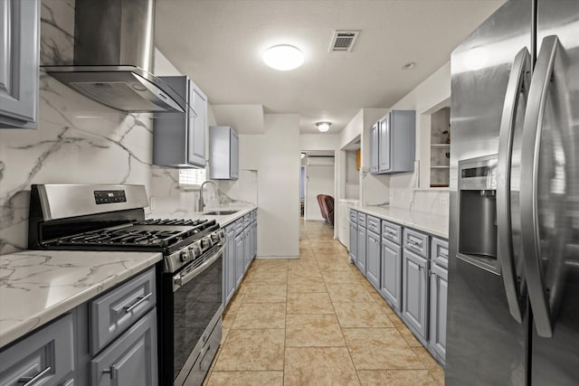 2648 Mark Dr, Mesquite, TX 75150 - kitchen featuring stainless steel appliances, wall chimney exhaust hood, gray cabinets, and backsplash