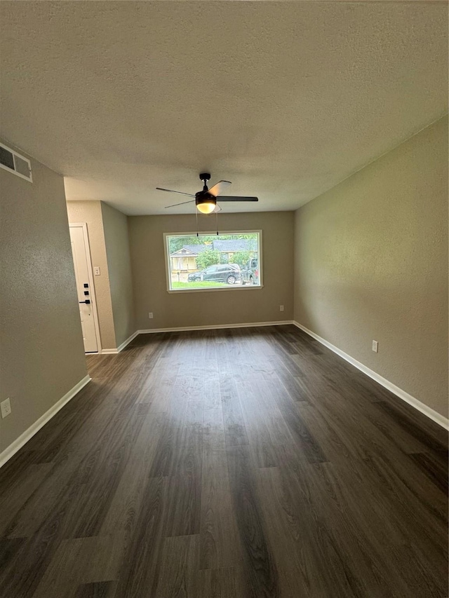2410 W Collin St, Corsicana, TX 75110 - empty room featuring dark wood-type flooring, a textured ceiling, and ceiling fan