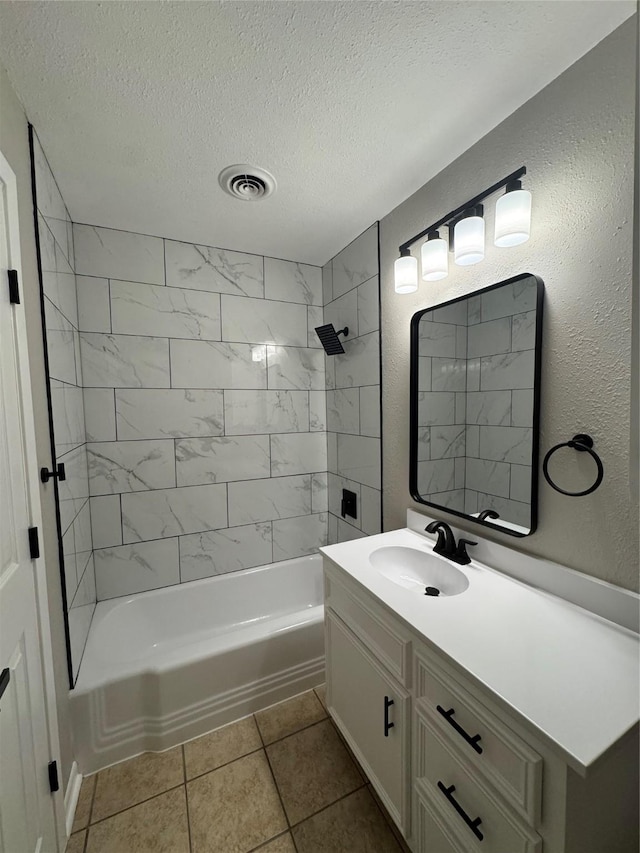 2410 W Collin St, Corsicana, TX 75110 - bathroom featuring vanity, a textured ceiling,  shower combination, and tile patterned flooring