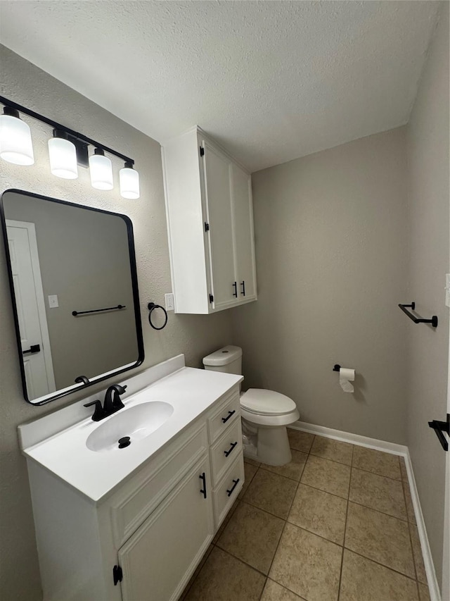 2410 W Collin St, Corsicana, TX 75110 - half bath with a textured ceiling, vanity, and tile patterned flooring