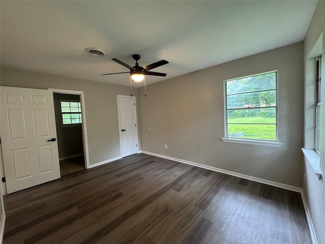 2410 W Collin St, Corsicana, TX 75110 - unfurnished bedroom with dark wood finished floors and a ceiling fan