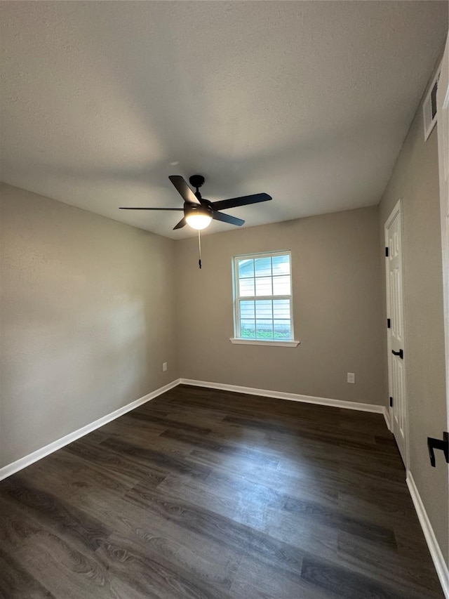 2410 W Collin St, Corsicana, TX 75110 - spare room featuring ceiling fan, dark wood-type flooring, and a textured ceiling