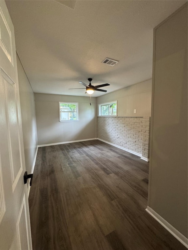 2410 W Collin St, Corsicana, TX 75110 - unfurnished room featuring dark wood-style flooring, ceiling fan, and a textured ceiling