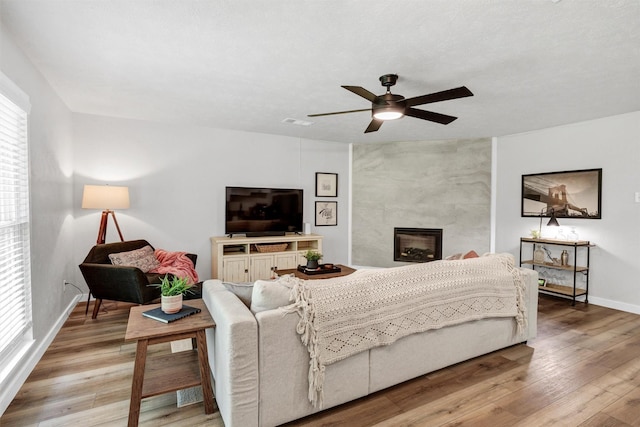 7116 Chapman Dr, North Richland Hills, TX 76182 - living room with light wood-style floors, a ceiling fan, and a premium fireplace