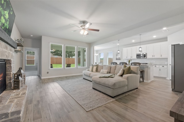 1420 Whitetail Ln, Azle, TX 76020 - living room with a ceiling fan, light wood-type flooring, recessed lighting, and a stone fireplace