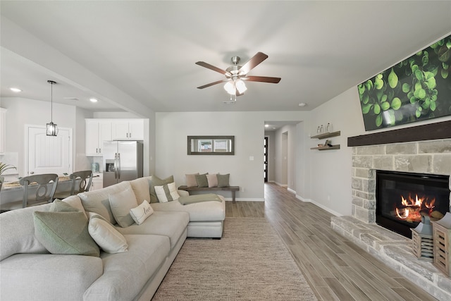 1420 Whitetail Ln, Azle, TX 76020 - living room featuring light wood-style floors, ceiling fan, recessed lighting, and a stone fireplace