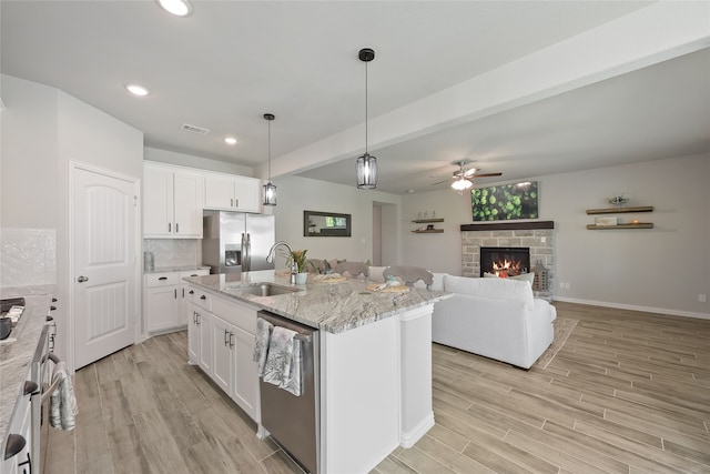 1420 Whitetail Ln, Azle, TX 76020 - kitchen with stainless steel appliances, a ceiling fan, light wood-style flooring, white cabinetry, and recessed lighting