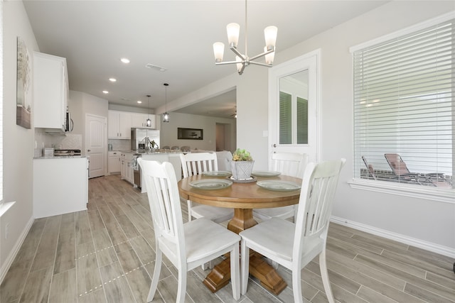 1420 Whitetail Ln, Azle, TX 76020 - dining room with wood finish floors, a chandelier, and recessed lighting